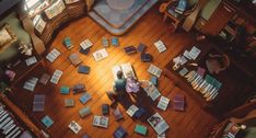 an overhead view of a living room filled with furniture and books