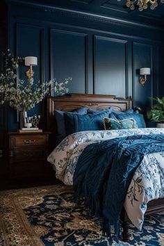 a bedroom with dark blue walls and furniture