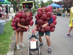 two people with balloons on their heads are standing next to a stroller