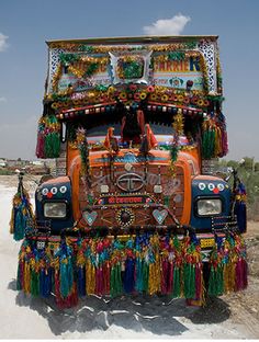 an elaborately decorated truck is parked in the desert