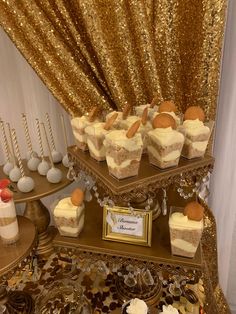 a table topped with cakes and desserts covered in gold sequins