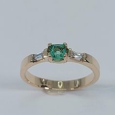 This stunning Emerald and Diamond Ring has been carefully crafted in warm 10K Yellow Gold , Authentic Emerald and Diamonds. Great for any occasion! Buy it for your-self or buy it for someone you love! Ring Weight and Stones Measurements: Ring weights 2.5 grams. Material: 10K Yellow Gold, Emerald and Diamonds Emerald Measurements:  3.5 mm  (Color:Green) Diamonds: 2 Diamond Baguette: 3.0 mm x 1.5 mm each , 0.06 ct Total Weight: 0.12 ct Ring Size: 7 1/2  All of my jewelry is handmade from scratch a Emerald Rings With Accent Stones Princess Cut, Emerald Ring With Princess Cut And Accent Stones, May Birthstone Ring With Princess Cut Center Stone, May Birthstone Princess Cut Ring With Center Stone, Princess Cut Ring With May Birthstone, Heirloom Style Emerald Ring With Accent Stones, Heirloom Emerald Ring With Accent Stones And Round Cut, Heirloom Emerald Ring With Accent Stones, Heirloom Emerald Baguette Cut Ring