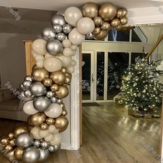 the balloon arch is decorated with silver, gold and white balloons for an elegant christmas party