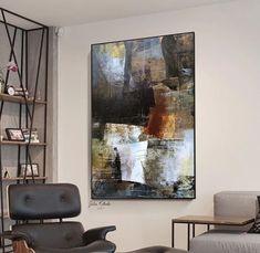 a living room filled with furniture and a painting on the wall