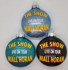 three ornaments with the show live on tour written on them