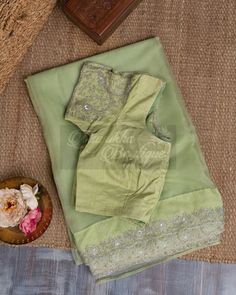 "The Pure Organza Pastel Green Saree Is A Delicate And Elegant Piece Of Clothing That Exudes Grace And Sophistication. The Subtle Pastel Green Base Adds A Touch Of Refinement To The Saree, Making It Perfect For Formal Occasions. The Saree Is Adorned With All-Over Hand Embroidery Over The Borders With Fine Threads Of Golden And Silver, Which Add A Touch Of Shimmer And Shine To The Saree. The Blouse That Comes With The Saree Is Heavily Embroidered , Which Perfectly Complements The Intricate Embroi Pista Green Chanderi Blouse Piece For Reception, Festive Semi-stitched Pista Green Blouse, Dola Silk Blouse For Reception And Transitional Season, Fitted Raw Silk Saree With Dori Work, Fitted Raw Silk Saree With Resham Embroidery, Festive Pista Green Blouse Piece With Chikankari Embroidery, Fitted Pre-draped Saree With Resham Embroidery In Raw Silk, Elegant Embroidered Pista Green Blouse Piece, Pista Green Blouse Piece With Chikankari Embroidery