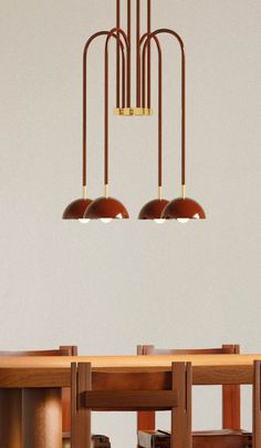 three lamps hanging from the ceiling above a dining room table