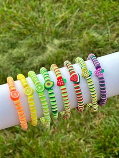 a close up of a person holding a white pole with bracelets on it's arm