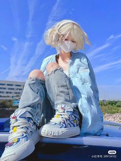 a person sitting on the hood of a car with their feet up and wearing sneakers