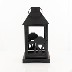 a black lantern with an elephant and giraffe silhouette on it