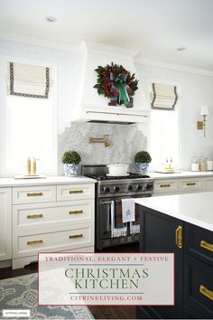 a christmas wreath is hanging on the wall above an oven in a white and black kitchen