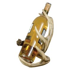 a wine bottle holder with deer antlers on it's sides and a glass bottle in the middle