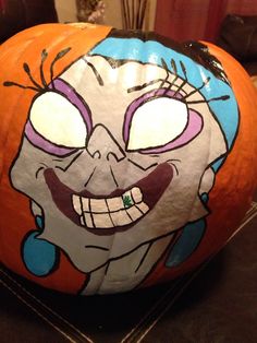 an orange pumpkin with a cartoon character painted on it