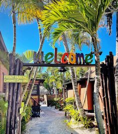 the welcome sign to an island resort with palm trees