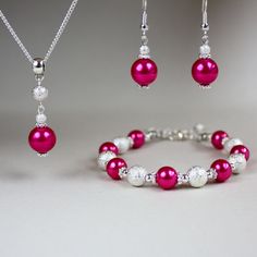 A contemporary 3-piece jewellery set featuring faux glass pearls in hot pink colour and bright silver plated stardust beads. Perfect for any occasion, weddings and parties or as a gift. Set contains pendant style necklace with a delicate silver plated chain, beaded bracelet and a pair of drop earrings. Organza gift bag included!  Please note that although I take a great care to keep the colours on the photographs as close to reality as possible, they may look slightly different on different moni Handcrafted Jewelry Boho, Hot Pink Jewelry, Bridesmaid Jewellery, Pink Jewelry Set, Pink Pearl Necklace, Crochet Earrings Pattern, Diy Jewelry Unique, Wedding Bridesmaid Jewelry, Gifts Bridesmaid