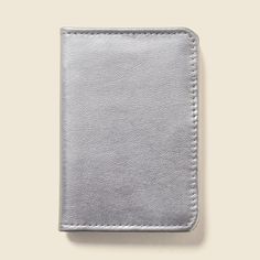 a silver leather wallet sitting on top of a table