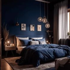 a bedroom with dark blue walls and lights hanging from the ceiling, along with a large bed