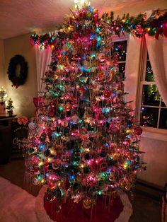 a brightly lit christmas tree in a living room