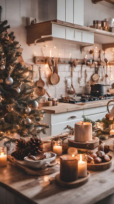 a christmas tree with lit candles in front of it and other decorations on the counter