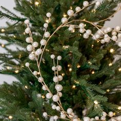 a christmas tree decorated with white balls and lights