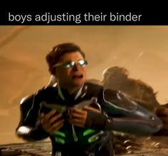 an image of a man holding a video game controller in his right hand and the caption says boys adjusting their binder