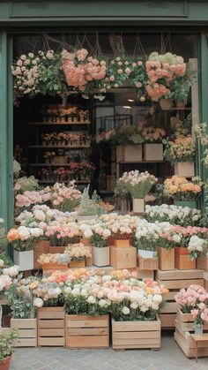 a flower shop with lots of flowers in the window