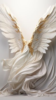 an artistic white sculpture with gold wings