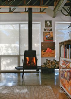 a living room with a wood burning stove in it