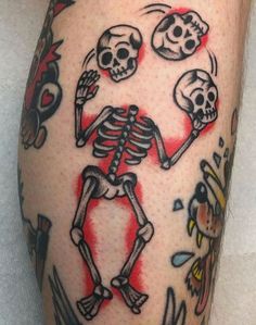 a man's leg with tattoos on it that has skulls and flowers all over it