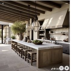 a large kitchen with an island in the middle and lots of stools around it