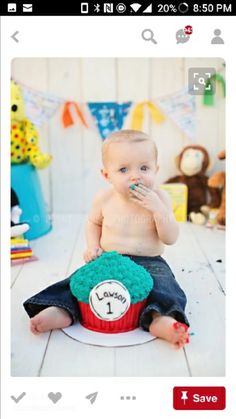 a baby sitting on the floor eating cake