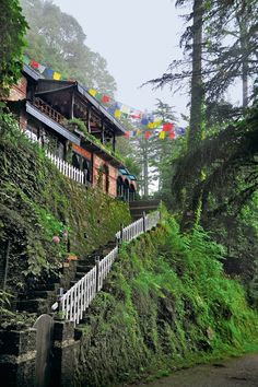 there are many umbrellas on the roof of this house in the mountains above it