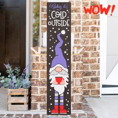 a wooden sign that says baby it's cold outside with an image of a gnome