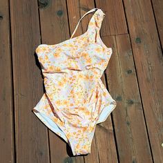 Kon Sol Woman's One Piece Swimsuit. Size Medium. Check Measurements. Floral Orange, Pink And White. One Adjustable Strap On The Left Side. There Is Boning On The Sides By The Bra And Gathering Along The Sides. Stretch Pink One Piece For Spring, Pink Stretch One-piece For Spring, Spring Pink Stretch One Piece, Spring Pink Stretch One-piece, Pink Stretch One-piece For Summer, Pink One-piece Bodysuit For Spring, Pink Bodysuit For Beach In Spring, Peach Stretch Swimwear For Spring, Peach Swimwear For Spring Beach Party