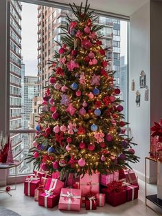 a christmas tree with presents under it in the middle of a living room next to a large window