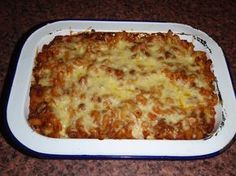 a casserole dish with cheese and meat in it