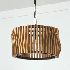 a wooden light fixture hanging from a ceiling