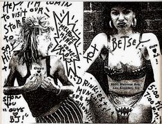 two women with tattoos on their bodies and writing all over the wall behind them in black and white