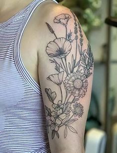 a woman with a flower tattoo on her arm