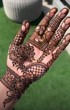 the hand is decorated with henna designs on it