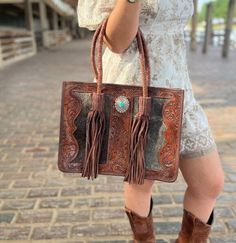 Hand made tote bag with beautiful hand tooling and genuine leather & cowhide. Conceal Carry Hidden Compartment Western Hand-tooled Bag For Daily Use, Western Hand Tooled Bags For Daily Use, Western Style Hand-tooled Bag For Daily Use, Western Style Hand-tooled Bags For Everyday Use, Western Style Hand Tooled Brown Bag, Western Style Brown Bags For Daily Use, Hand Tooled Western Bags, Western Style Leather Rectangular Shoulder Bag, Tooled Leather