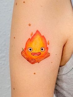 a woman's arm with a fire tattoo on it