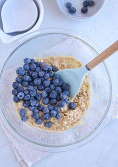 a glass bowl filled with oatmeal and blueberries