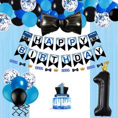 a blue and black birthday party with balloons, streamers, bow ties and cake