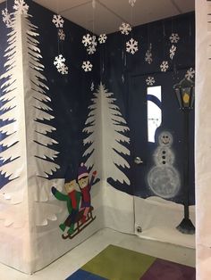 a room decorated with paper snowmen and trees