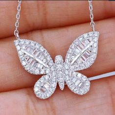 Turn heads with our 1" Fully Baguette-Set Butterfly Pendant, a captivating piece that embodies both elegance and whimsy. Each wing of the butterfly is adorned with meticulously set baguette-cut cubic zirconia stones, creating a dazzling display of light and brilliance. Finished with rhodium electroplating, this pendant offers a refined platinum look that exudes luxury. Perfect for making a statement, whether you're dressing up for a special occasion or adding a touch of glamour to your everyday Sparkle Gift, Delicate Pendant, Detailed Necklace, Party Necklace, Friendship Necklaces, Butterfly Pendant Necklace, Pendent Necklace, Butterfly Necklace, Butterfly Pendant