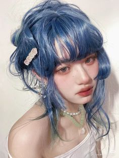 a young woman with blue hair and bangs