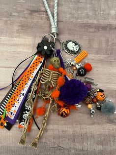 a collection of halloween items is laying on the floor next to a keychain