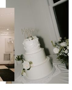 a white wedding cake sitting on top of a table