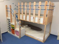 a bunk bed with ladders on the top and bottom is made out of wood